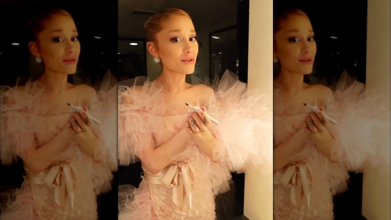 Ariana Grande wearing a ballerina bun and pink dress