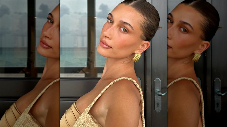 Hailey Bieber with a middle-parted bun