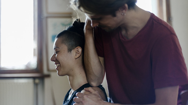 A partner giving other partner a shoulder massage