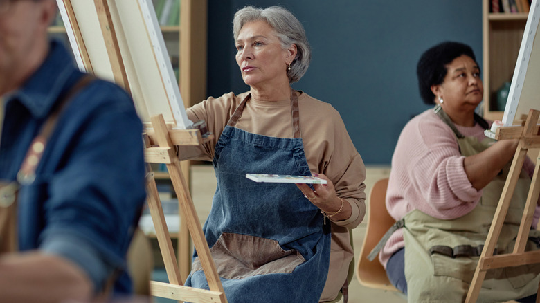 older people in a painting class