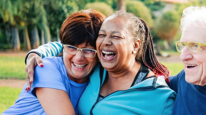 elder people embracing and smiling