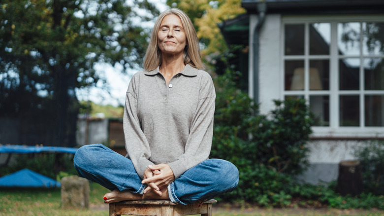 woman sitting outside meditating