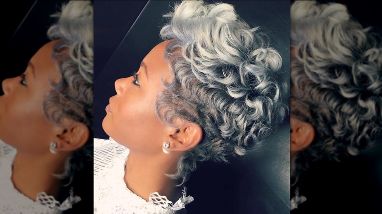 person with gray curly pixie