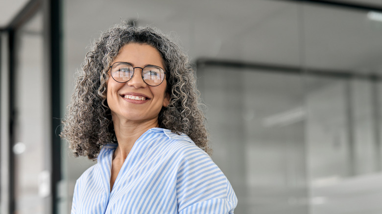 Smiling woman with curly gray hair