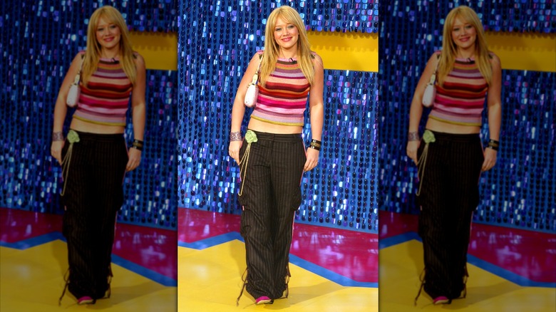 Lizzie McGuire on the red carpet in striped trousers and a pink top