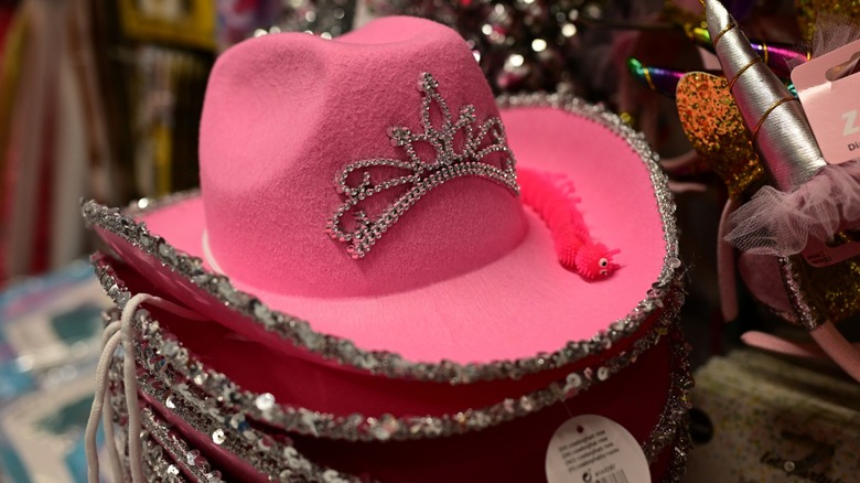 Close-up of a stack of pink cowgirl hats with attached tiaras