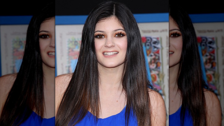 Kylie Jenner wearing orange eyeshadow and a blue dress