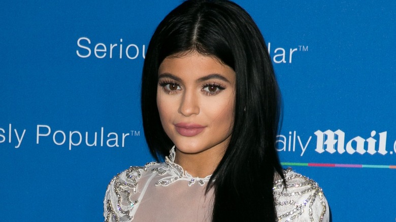 Kylie Jenner posing on the red carpet with powder on her face