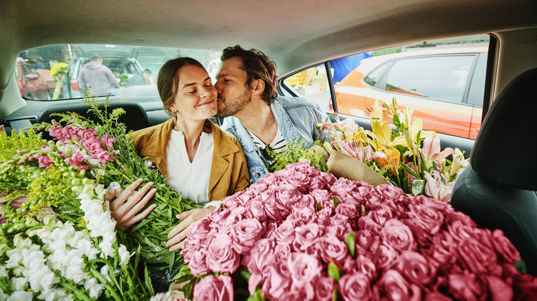 Couple in car with flowers