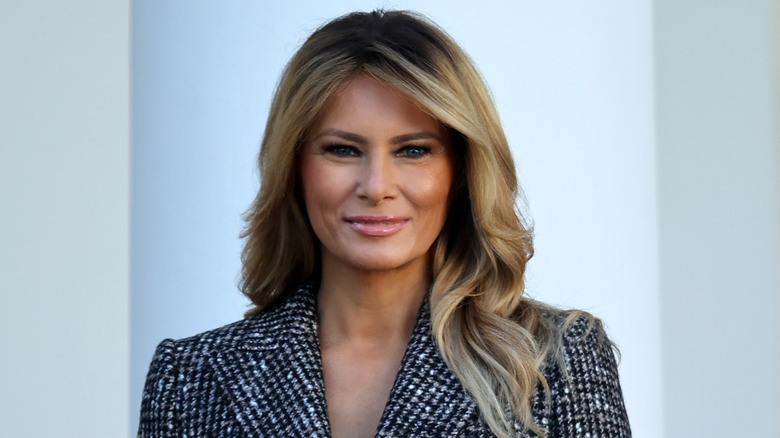 Melania Trump in a grey coat at an event