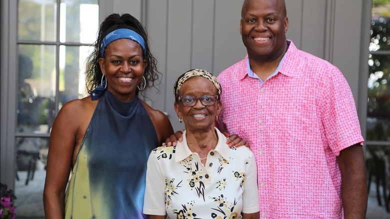 Michelle Obama stands next to her mother Marion Shields Robinson and brother Craig Robinson