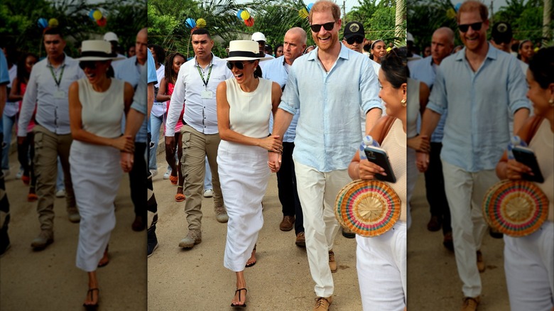 Meghan Markle in white and Prince Harry in blue shirt and white trousers in Columbia