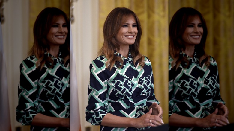 Melania Trump standing on a stage and smiling