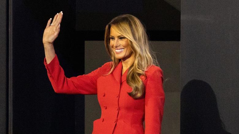 Melania Trump standing on stage and waving