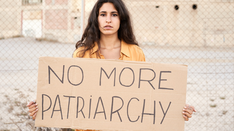 woman hold anti patriarchy sign