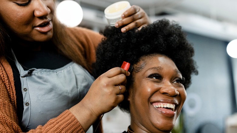 Woman smiling during hair cut