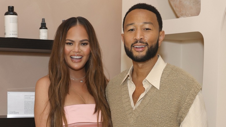 Chrissy Teigen posing with John Legend