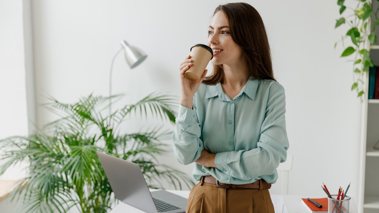 Woman at work drinking coffee