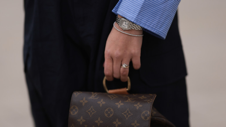 A close up of a woman's jewelry collection on her hand and wrist