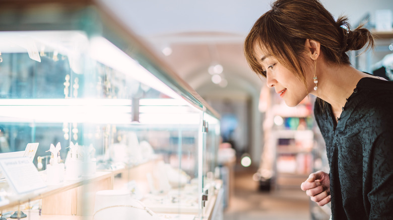 woman looking at jewelry at a store