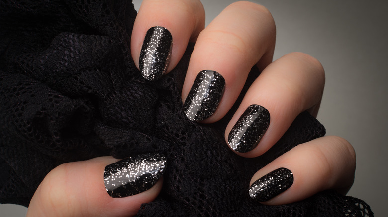 Black glitter nail manicure