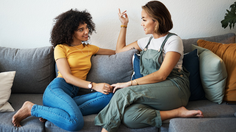 Two women talking on the couch