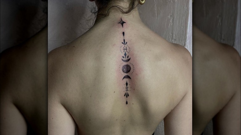 Pisces back and neck tattoo