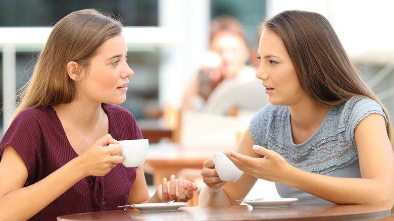 Two women talking at a coffee shop 