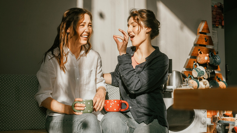 Two women talking and drinking coffee