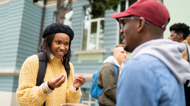 Woman talking to a man outside