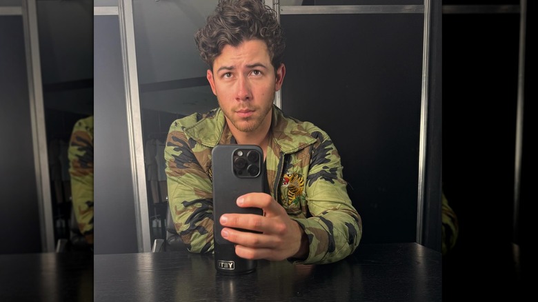 Nick Jonas taking a mirror selfie