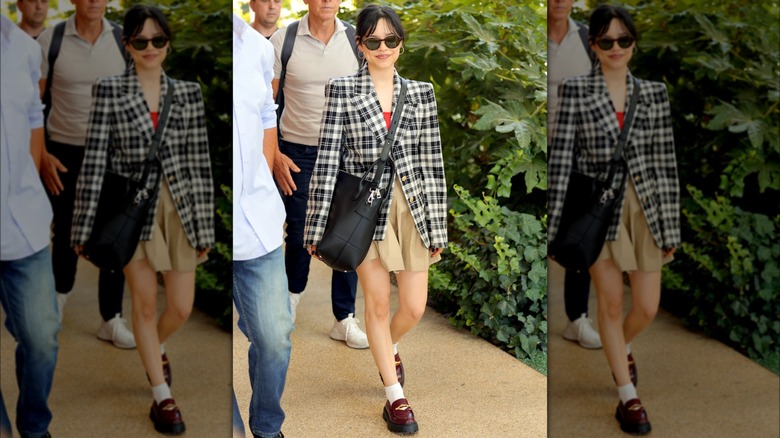 Jenna Ortega arriving ahead of the Venice Film Festival, wearing a beige skirt and black-and-white blazer