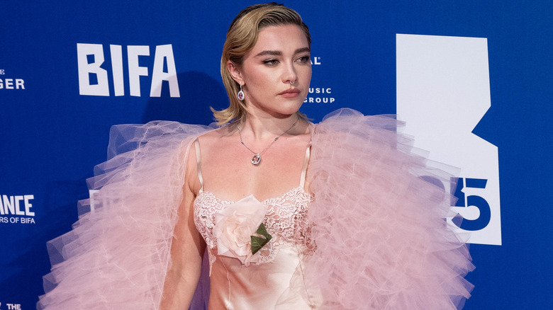 Florence Pugh wearing a flippy bob and a voluminous pink outfit