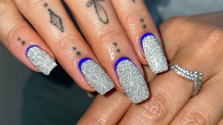 Nails with silver sparklers and blue at the bottom