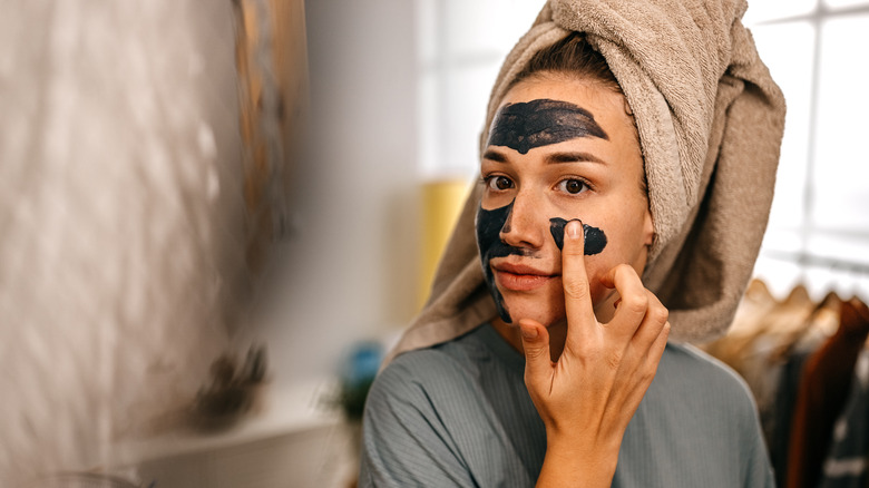 Woman applying a face mask 