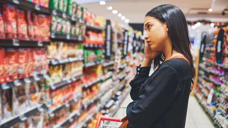 Woman looking at food in a supermarket
