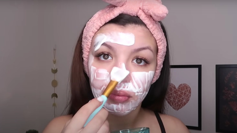 girl putting yogurt on face