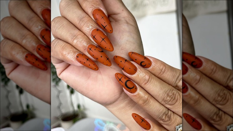 Orange nails with black nail art