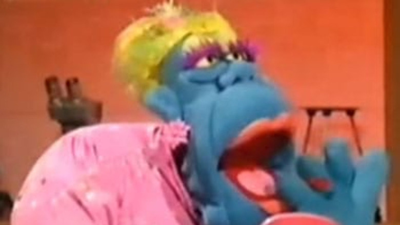 blue muppet with yellow hair