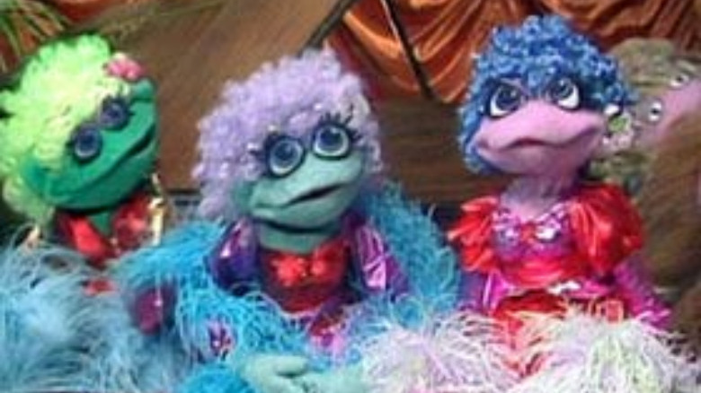 three muppets with curly hair