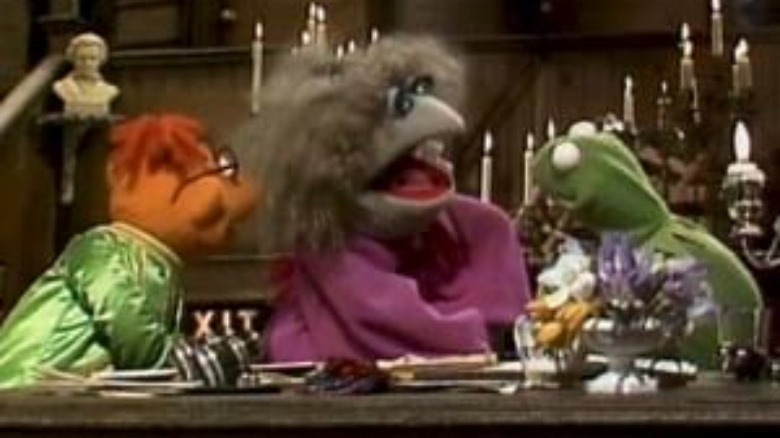 three muppets beind table