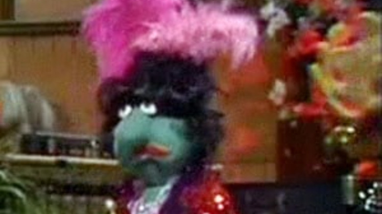 green muppet with pink hair