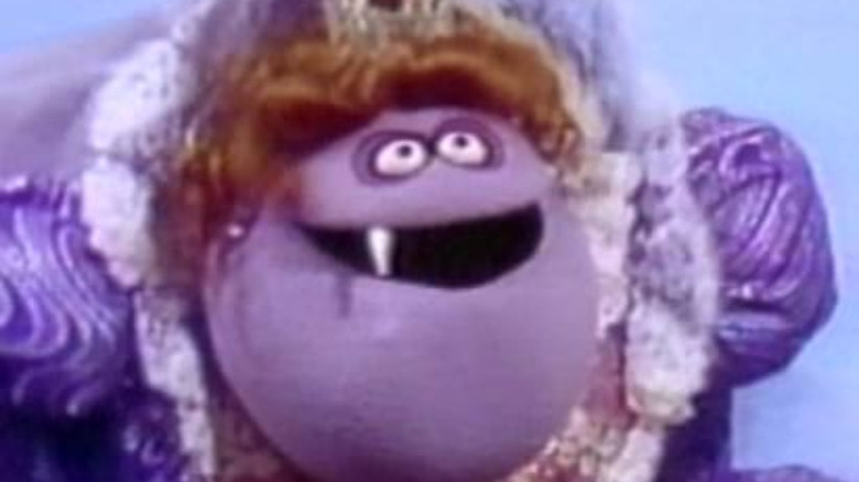 purple muppet with one tooth