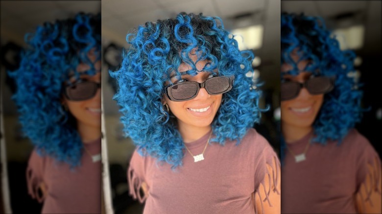 Black curly hair, blue tips