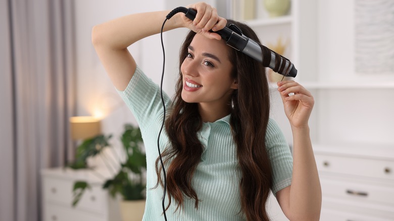 Woman curling hair