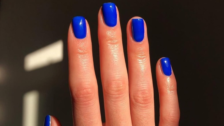 Close-up of a manicure with bright blue nails