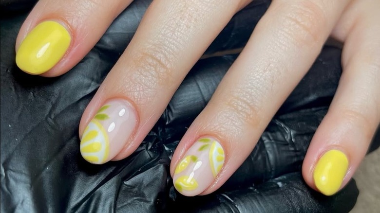 Close-up of yellow nails, some with lemons on them