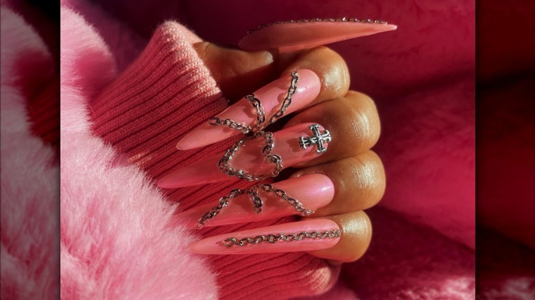 pink nails with silver chain jewelry