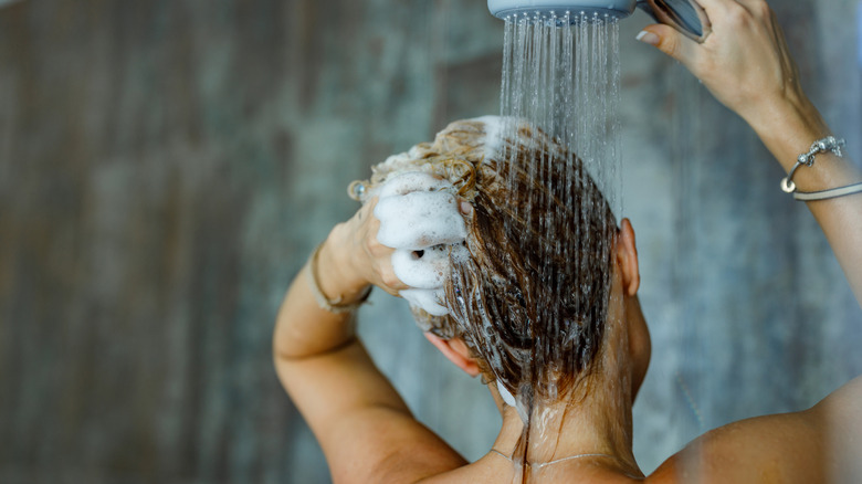 Back view of a woman washing her hair