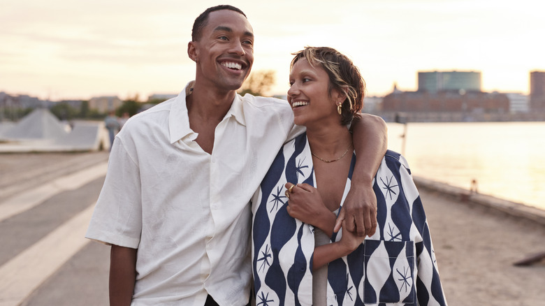 Happy man and woman taking a walk and smiling